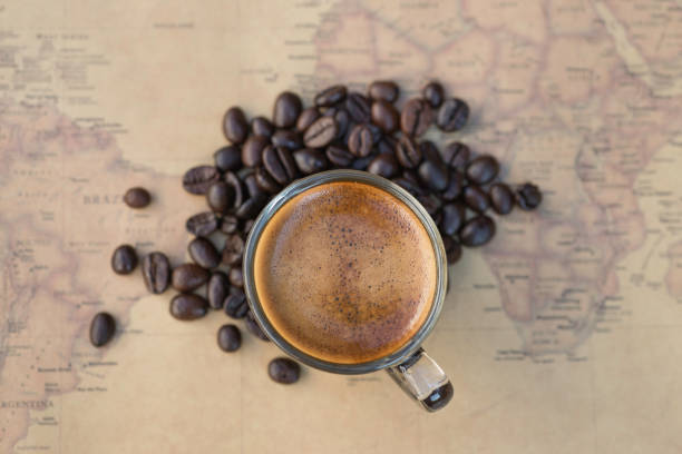 istock Black coffee with bean on world map background 1184808153