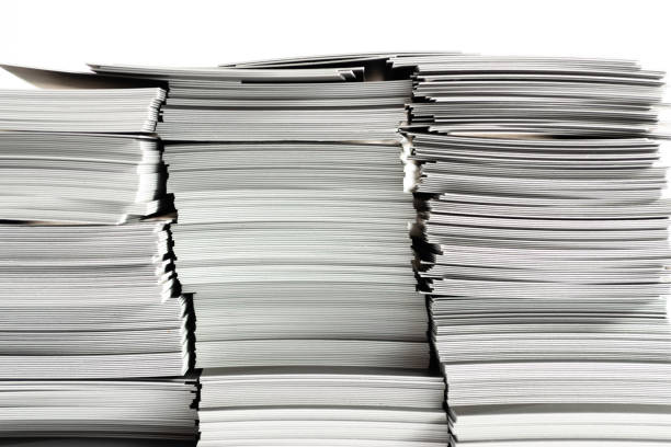 istock Stack of paper business cards close up on white background. Copy space. 1184808885