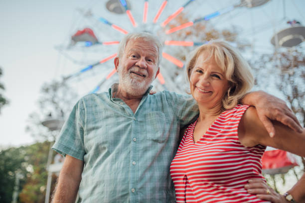 istock Elderly couple at the amusement park 1184809941