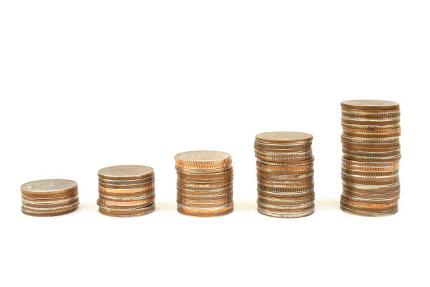 istock Growing pile of stacked silver coins isolated on white background. 1184811242