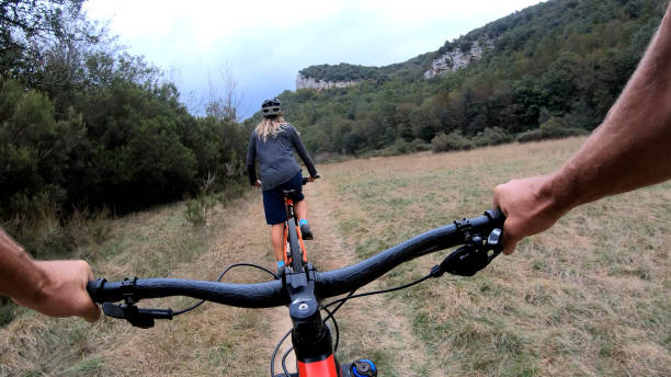 istock Mountain bikers ride along bike path 1184811431