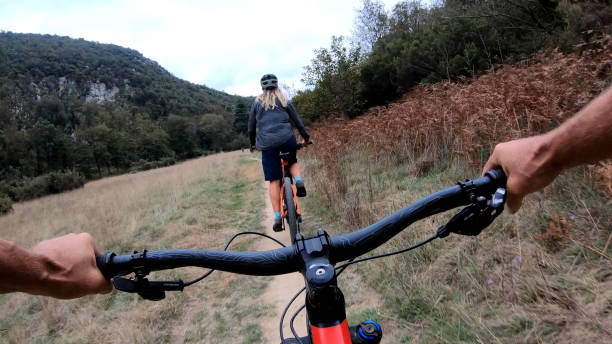 istock Mountain bikers ride along bike path 1184812432