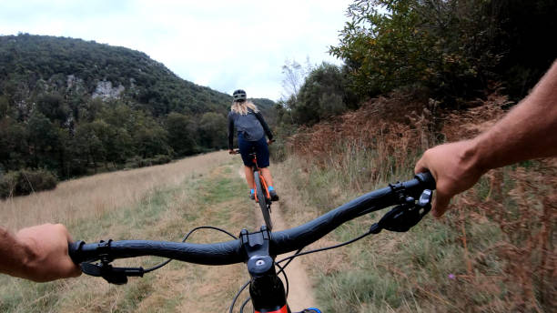 istock Mountain bikers ride along bike path 1184812563