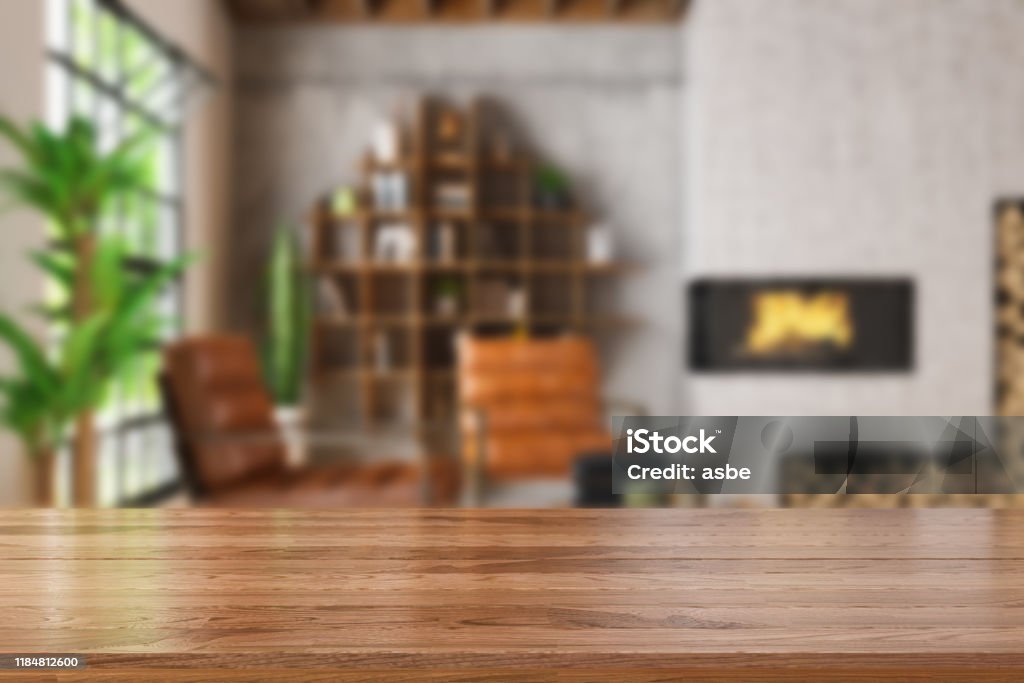 Tavolo in legno con sfocatura di accogliente soggiorno - Foto stock royalty-free di Tavolo