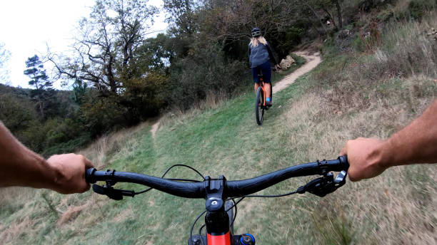 istock Mountain bikers ride along bike path 1184812639