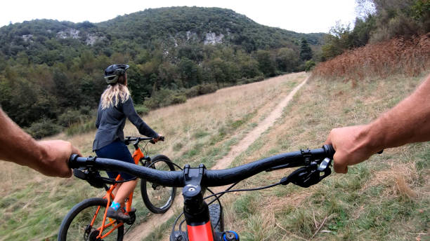 istock Mountain bikers ride along bike path 1184812686