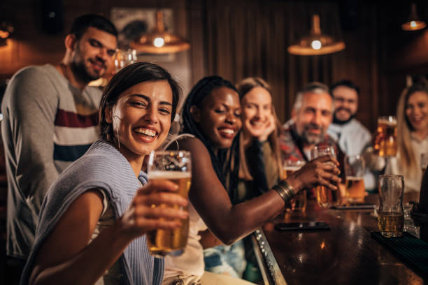 istock Group of friends drinking beer in the pub 1184813647
