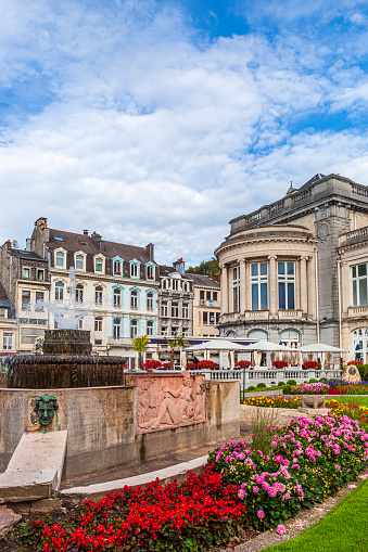 Casino and other buildings overlooking a flowered garden in the city centre of Spa, a city located in a valley of the Ardennes mountains, famous for its mineral waters.