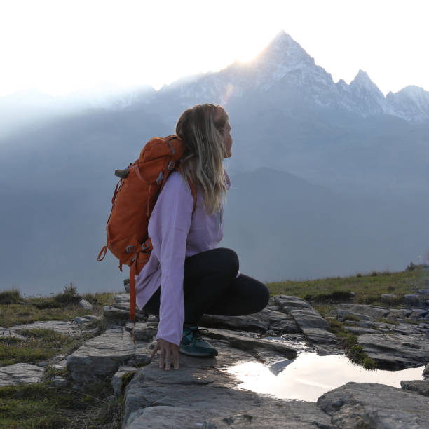 istock Young female hiker relaxes in mountainous meadow 1184816704