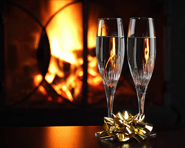istock Glasses with champagne in front of fireplace 118481692