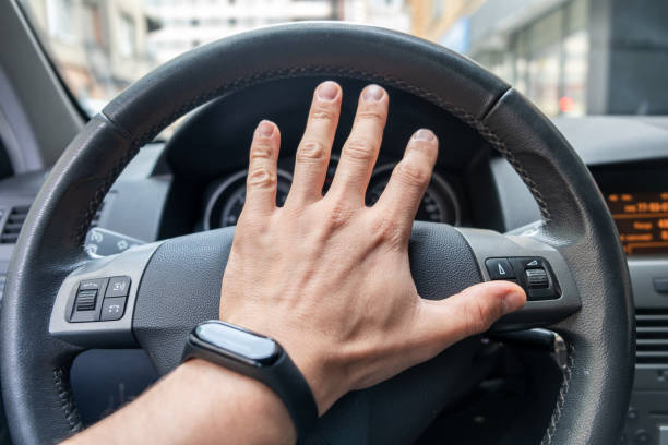 istock Drivers hand on a steering wheel of a car. 1184818237