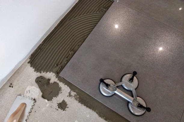 istock Ceramic tiles and tools for tiler. Floor tiles installation. Home improvement, renovation - ceramic tile floor adhesive, mortar, level 1184818385