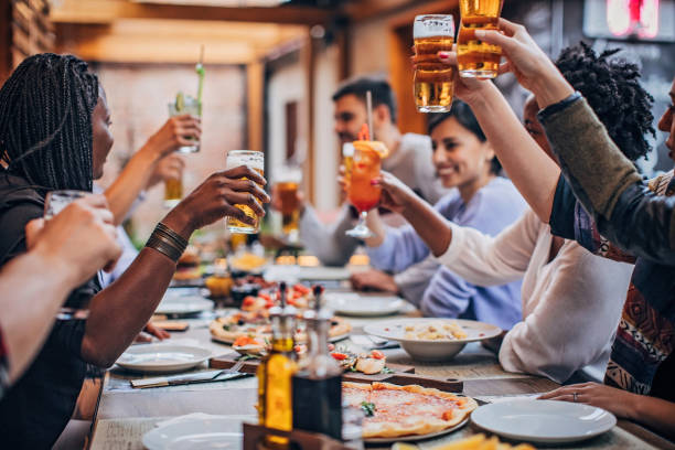 istock Friends sitting outdoors in restaurant 1184819514