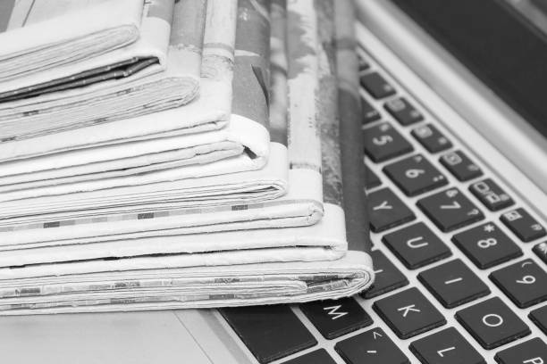 istock Newspapers and laptop. 1184819982
