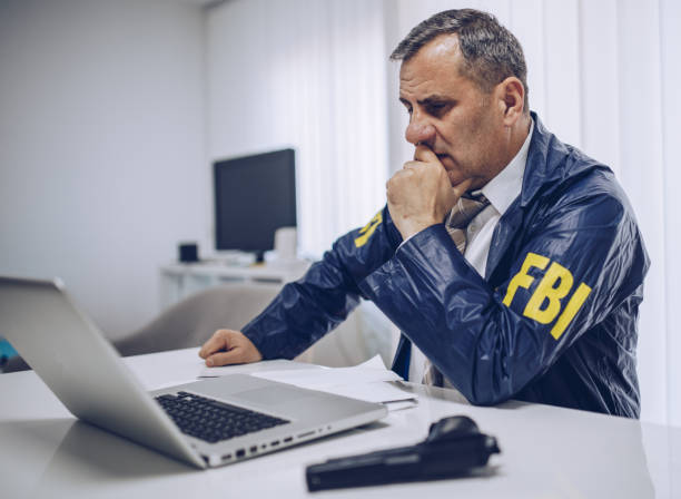 istock An old FBI agent uses a laptop in the office 1184820894