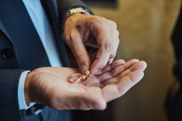 istock man holding wedding rings, groom getting ready in the morning before ceremony 1184820929