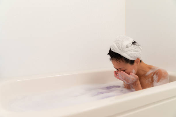 Woman relaxing in bubble bath