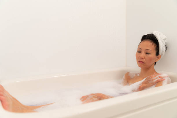 istock Woman relaxing in bubble bath 1184821071