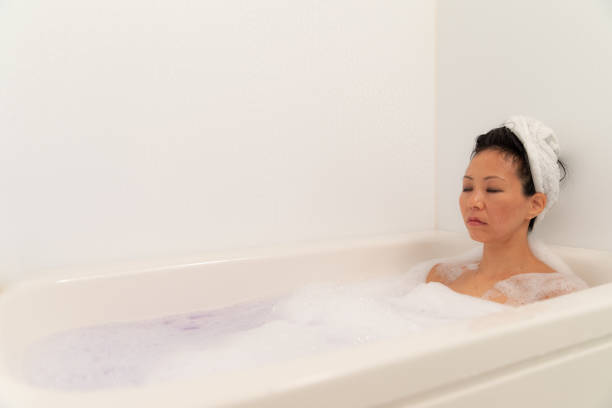 istock Woman relaxing in bubble bath 1184821104