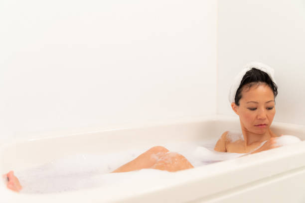 istock Woman relaxing in bubble bath 1184821134