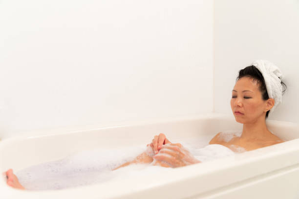 istock Woman relaxing in bubble bath 1184821176