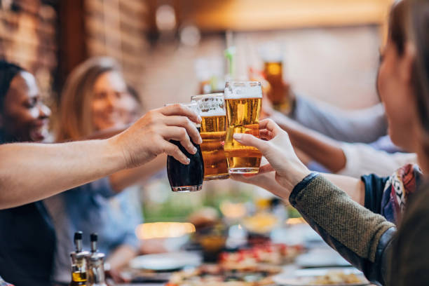 istock Group of friends drinking beer outdoors in the pub 1184822066