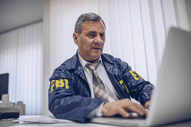 istock An old FBI agent uses a laptop in the office 1184823678