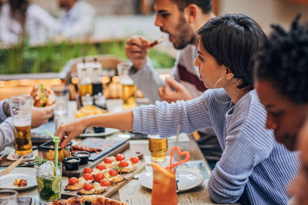 istock Group of friends on lunch outdoors in restaurant 1184824589