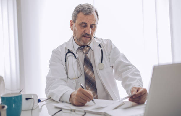 istock The old doctor works in a doctor's office 1184826360