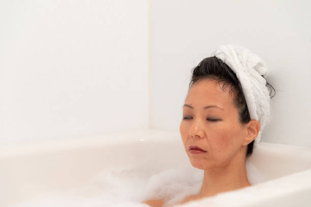 istock Woman relaxing in bubble bath 1184827836