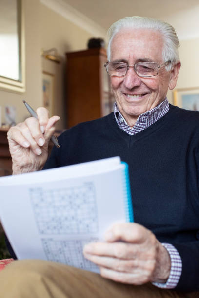 istock Senior Man Doing Sudoku Puzzle At Home 1184828242