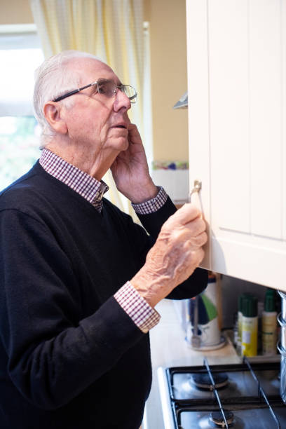 istock Forgetful Senior Man With Dementia Looking In Cupboard At Home 1184828246