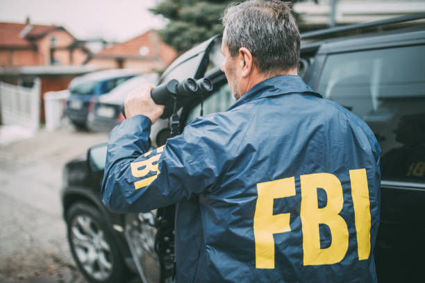 istock An old FBI agent uses binoculars 1184832126