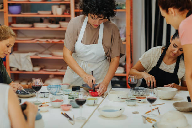 istock Group Of Women Learning How To Modeling Clay On Ceramics Classes 1184832509