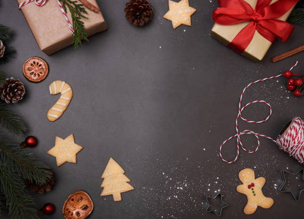istock Christmas composition with decorations and gift box with christmas cookie on black background. winter, new year concept. Flat lay, top view, copy space. 1184832739