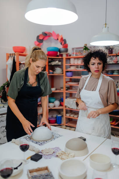 istock Group Of Women Learning How To Modeling Clay On Ceramics Classes 1184832788