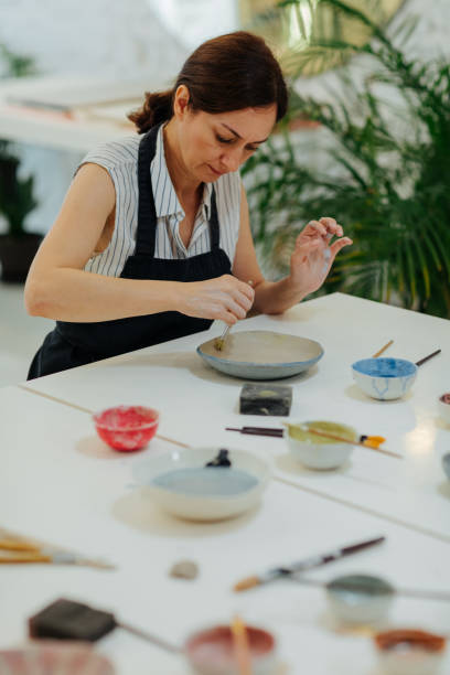 istock Woman Decorating Ceramics Bowl 1184833366