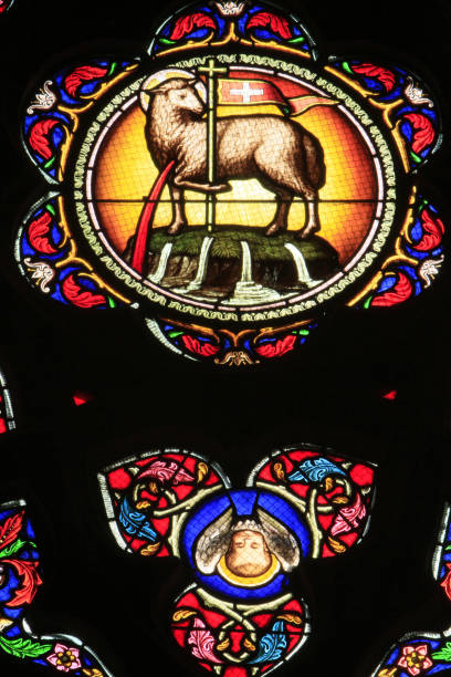 Lamb of God. Stained glass. Church of St. Madeleine. Montargis. France. Centre. Loiret. Montargis. October, 21, 2012. This colorful image depicts a stained glass window depicting the Lamb of God. Lobin Tour Workshops. 1859 1873. Church of St. Madeleine. agnus dei stock pictures, royalty-free photos & images
