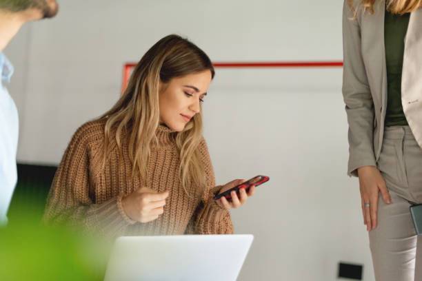 istock Young woman looking at mobile phone 1184836581