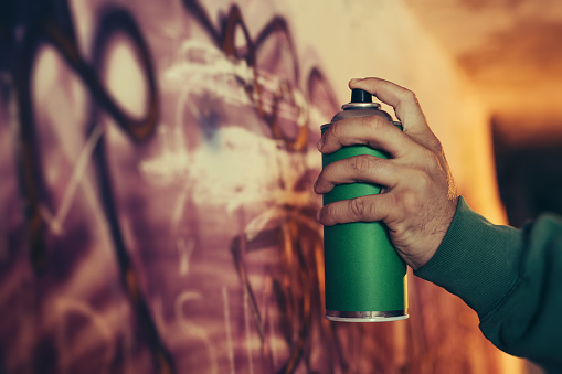 Graffiti Artist Drawing Graffiti on Wall