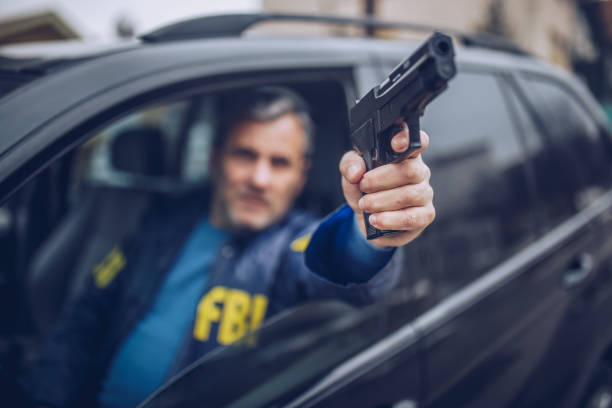 istock An FBI agent uses a gun in action 1184837679