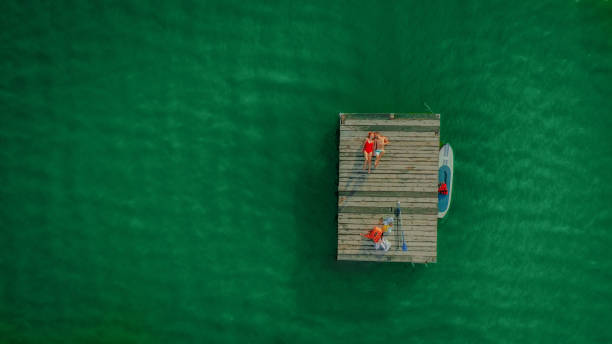 istock Young couple enjoy summer on a lake 1184838179