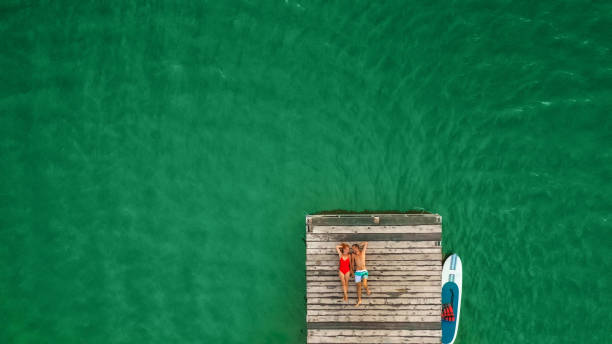 istock Young couple enjoy summer on a lake 1184838186