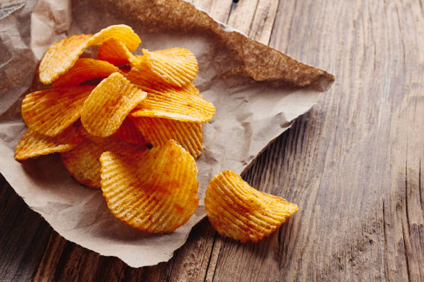 istock Potato chips on rustic wooden tabel 1184839684