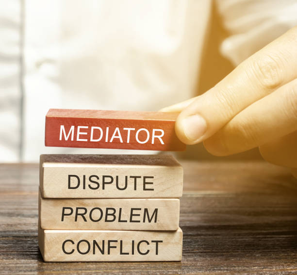 A man holds wooden blocks with the word Mediator, dispute, problem, conflict. Settlement of disputes by mediator. Dispute Resolution and Mediation. Third party, intermediary. A man holds wooden blocks with the word Mediator, dispute, problem, conflict. Settlement of disputes by mediator. Dispute Resolution and Mediation. Third party, intermediary. mediation photos stock pictures, royalty-free photos & images