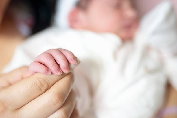 istock Baby Holding Mothers Hand 1184842314