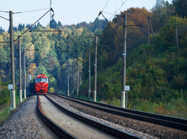 istock Train in the autumn. The train on the platform. The train pulls up to the platform. Public transport.Red train arriving to Vilnius, Lithuania. Travel concept. Travel 1184842325