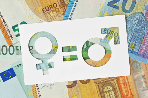 Male and female symbols on euro banknotes - Gender pay equality concept stock photo