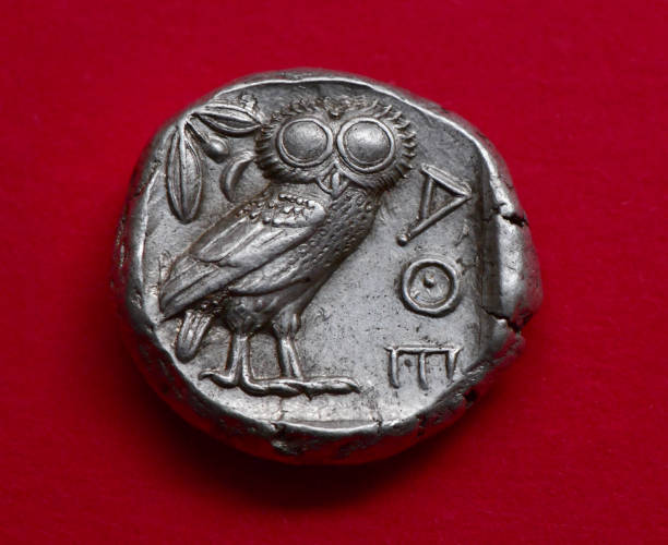 Ancient Greek Owl coin Ancient Greek coin  - from my own coin collection and over two thousand years old.
An Athenian Tetradrachm from after 499 BC, showing the owl of Athena and the Ancient Greek letters for Athens  - also an olive twig and crescent moon ancient coins of greece stock pictures, royalty-free photos & images