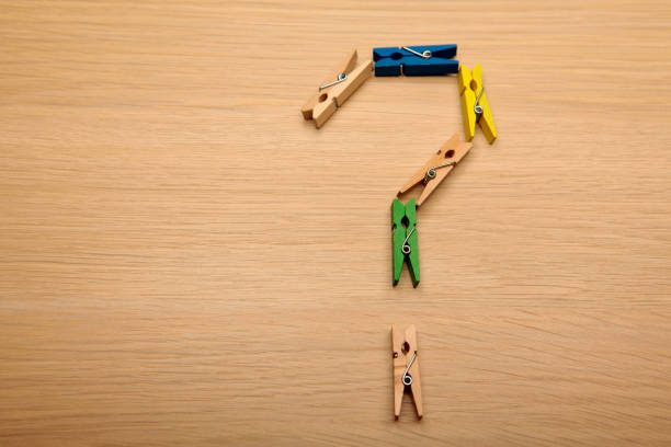 istock clothespin question mark wooden table background 1184845978